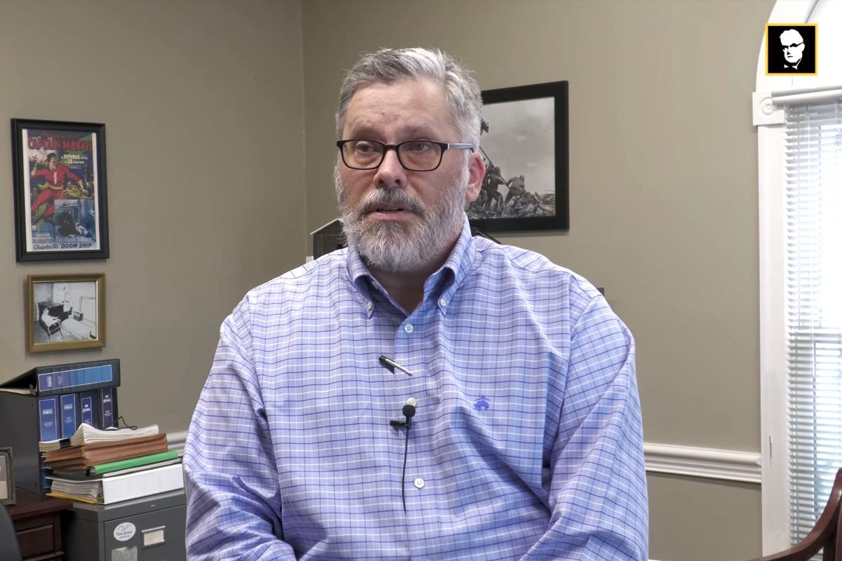 Layne Bruce speaking from inside his office