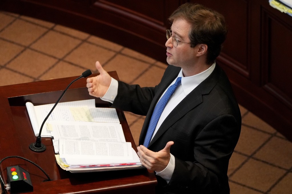 Attorney Lee Crain speaks from behind a podium
