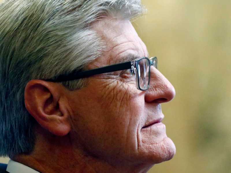 A closeup on Phil Bryant's face as he listens in to something above him