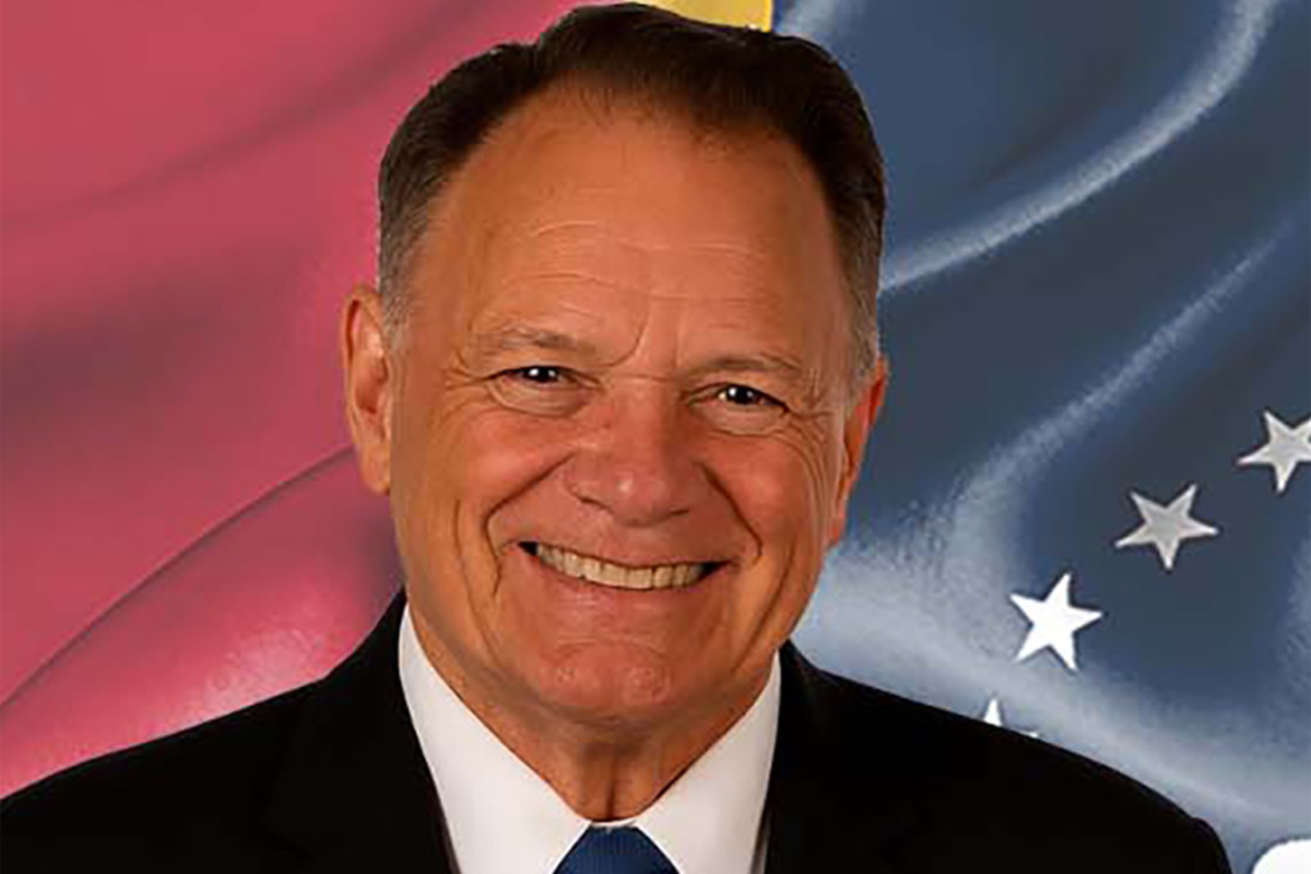 Albert Littell is pictured in front of an American flag inspired background