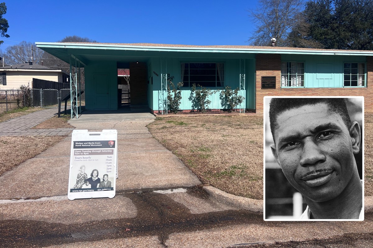 a small green and brick home has a sign in the driveway that says “Medgar and Myrlie Evers National Monument - open Tuesday through Saturday 9 am to 4 pm”