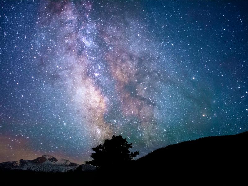 Stars and colored constellations in the night sky.