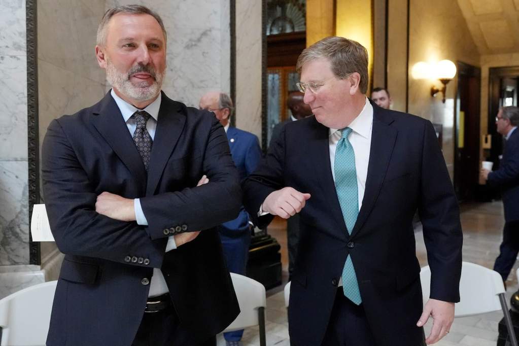 Tate Reeves nudges Jason White's elbow as they smile
