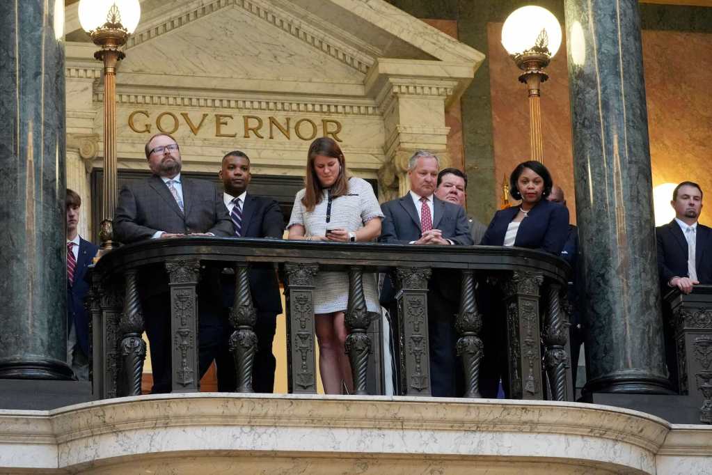 Several people gather on the balcony and look down. A doorway labeled 'Governor' is seen behind them.