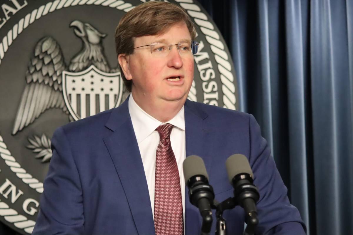 Gov. Tate Reeves speaking at a podium.