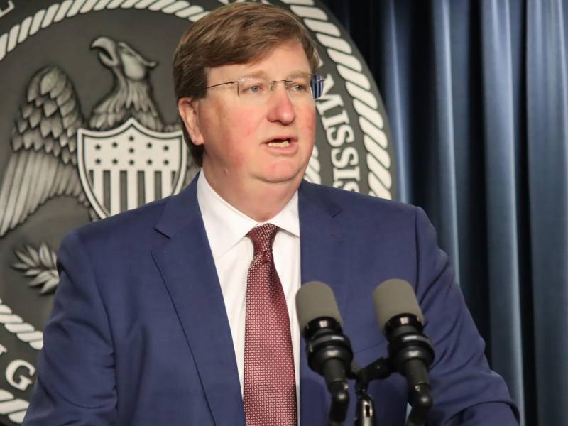 Gov. Tate Reeves speaking at a podium.
