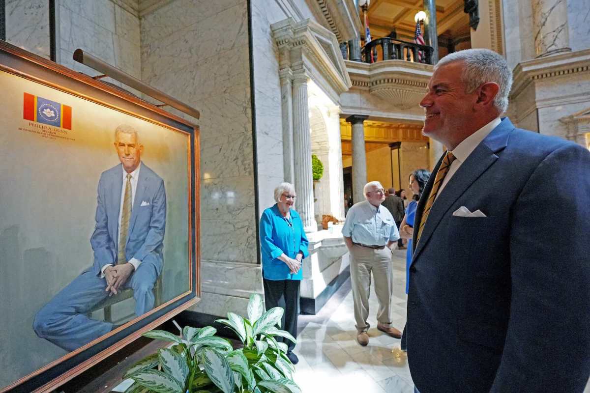 Philip Gun looks at his official portrait and smiles