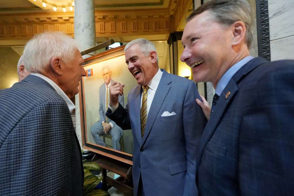 Philip Gunn talks to other lawmakers, everyone smiling