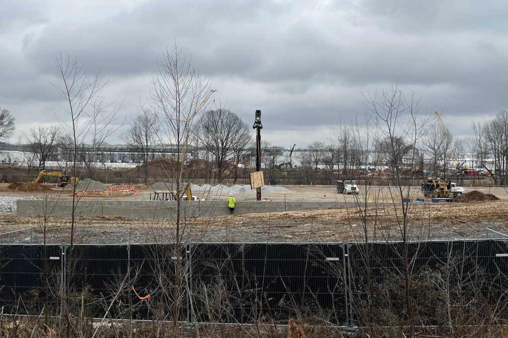 A construction space with a couple people working