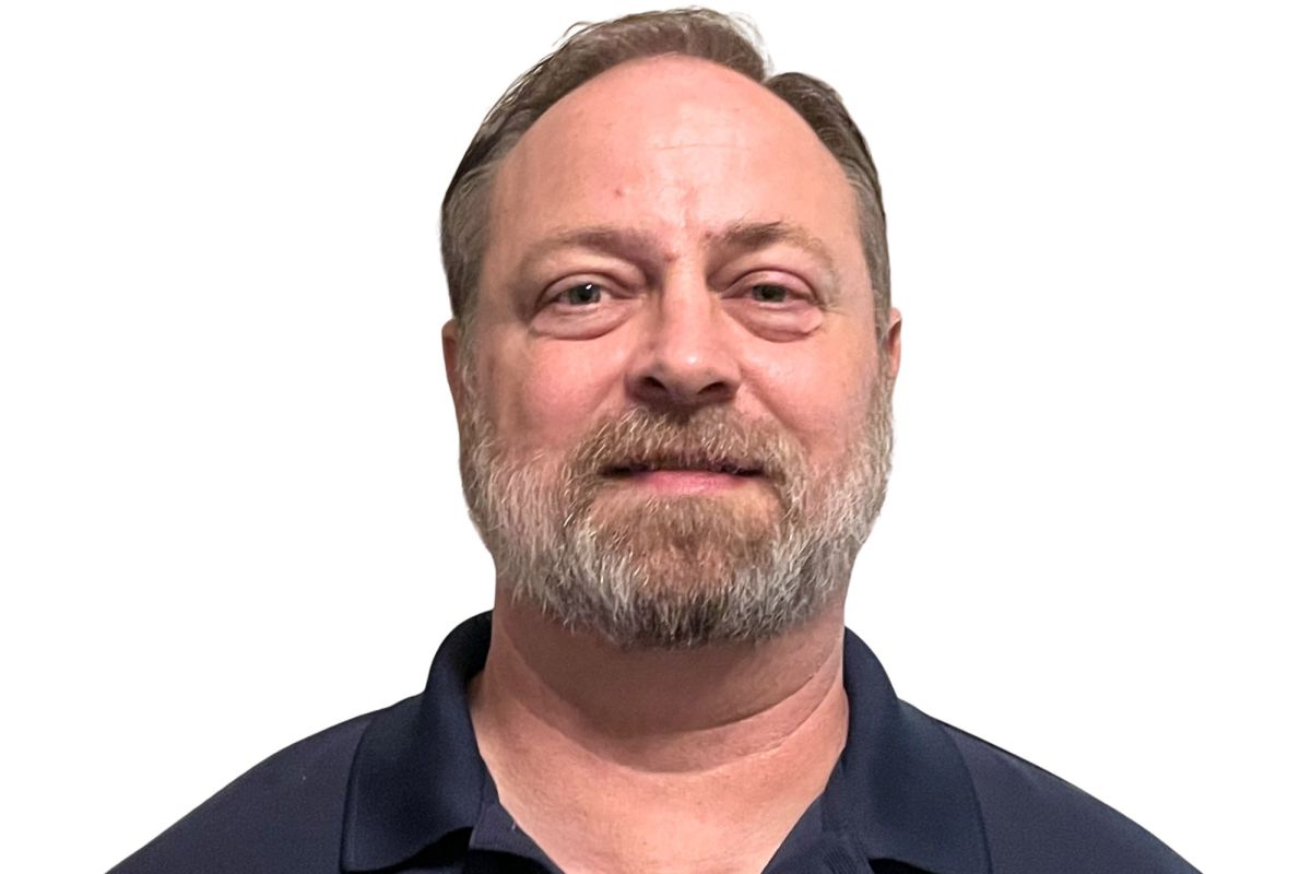 A close up photo of Erik Kiehle against a blank background