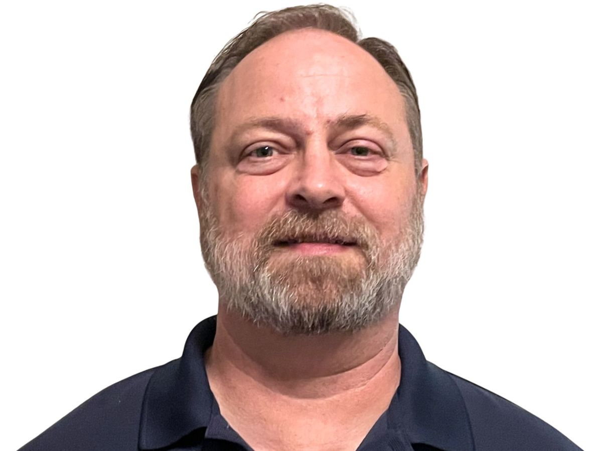 A close up photo of Erik Kiehle against a blank background