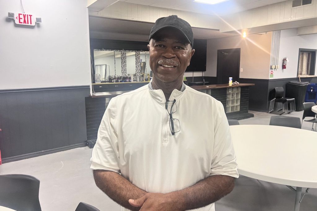 Larry Griggs, in a white polo shirt, smiling at an event