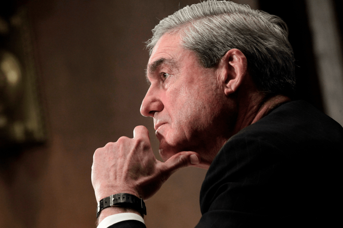 A closeup of Robert Mueller with his hand resting on his chin
