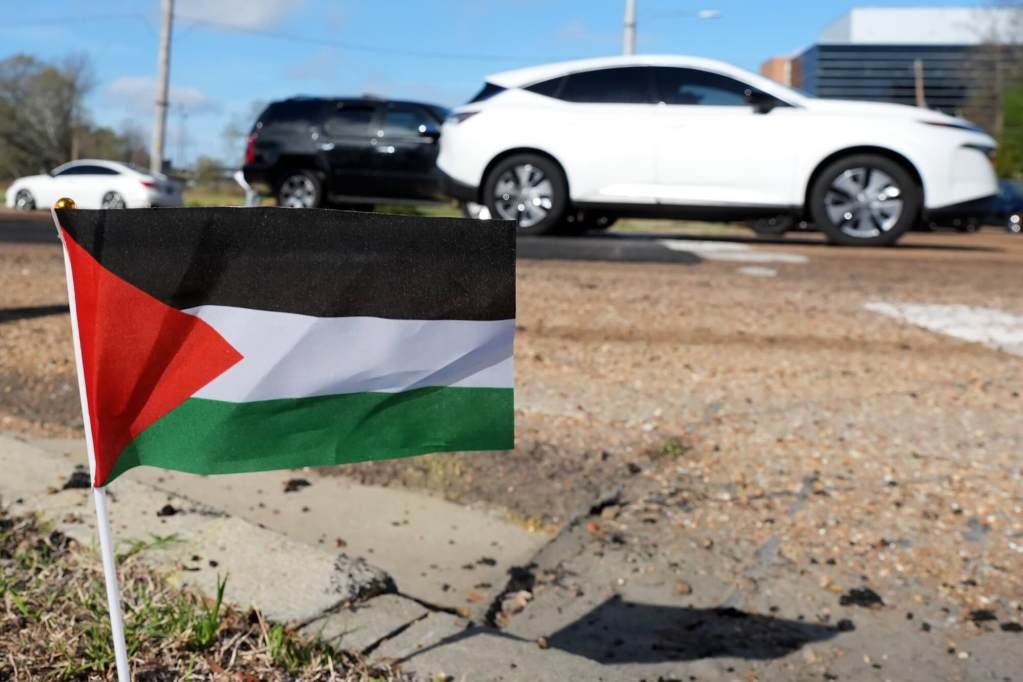 A small Palestinian flag planted on the roadside