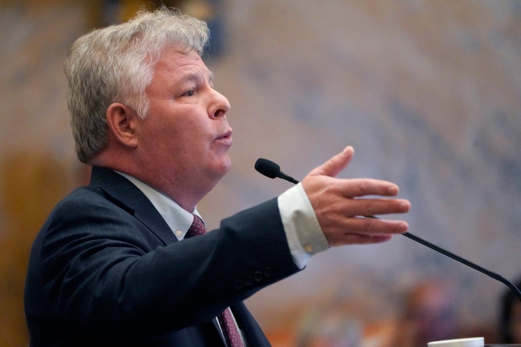 Rob Roberson speaks into a mic while making a gesture with his hand.