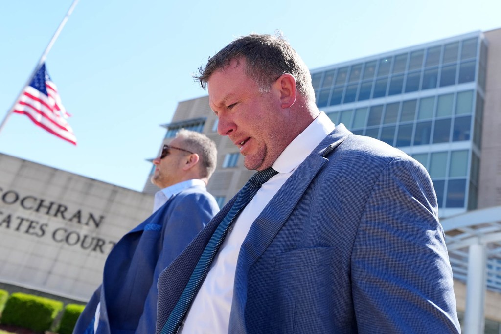 a photo of a man walking out of a court building