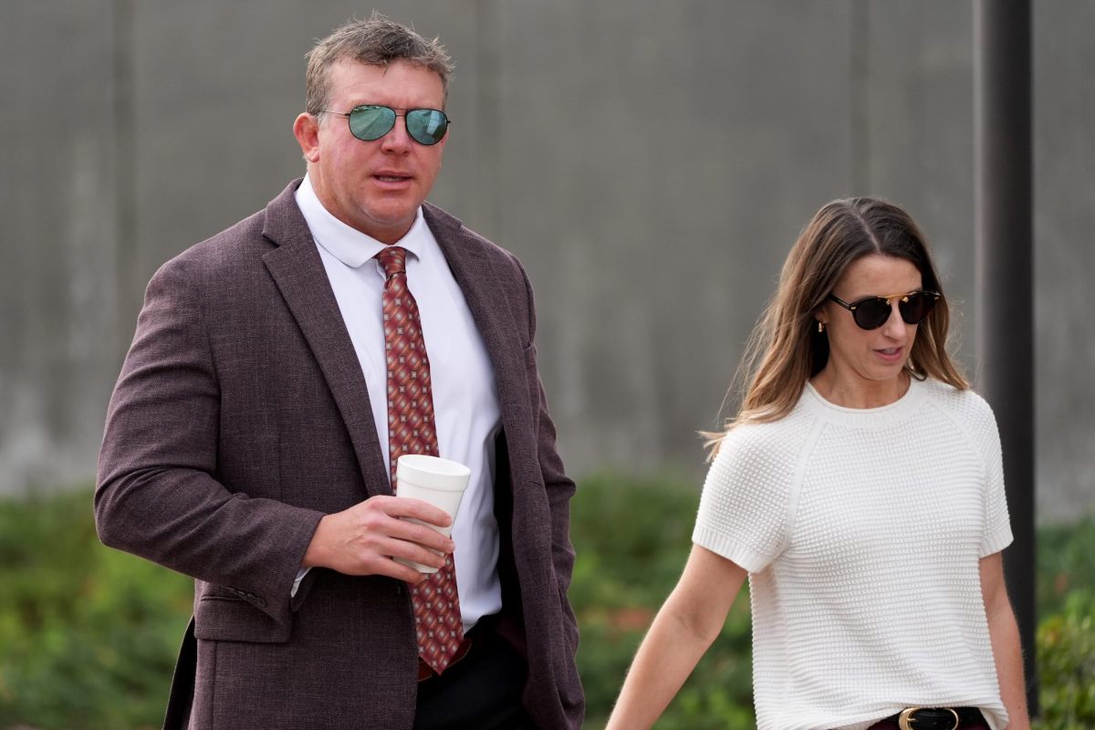 Ted DiBiase Jr. and his wife walk side by side outside
