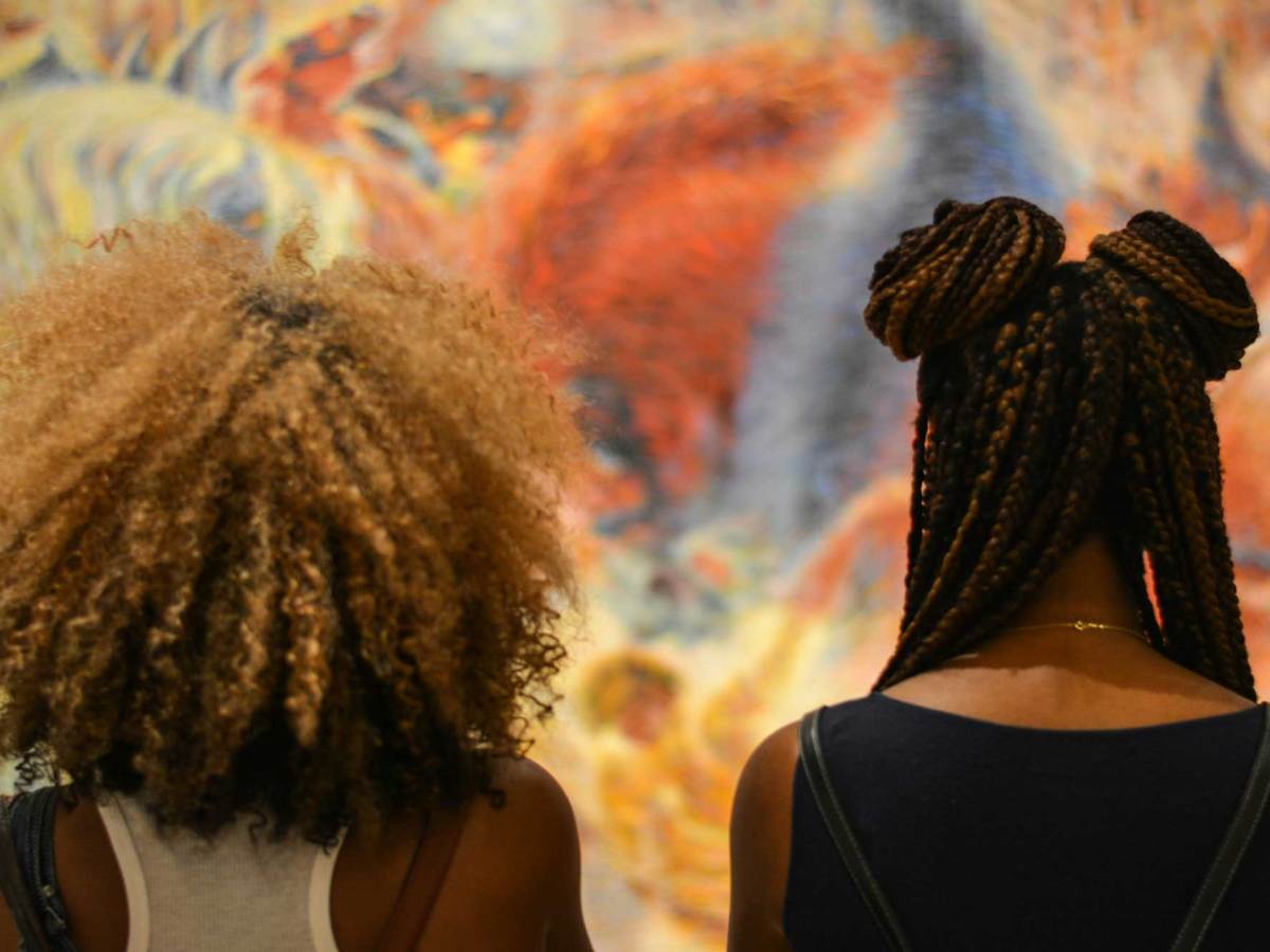 Two women photographed from behind with their hairstyles on display