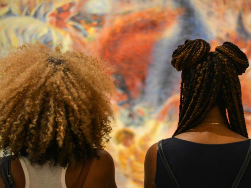 Two women photographed from behind with their hairstyles on display