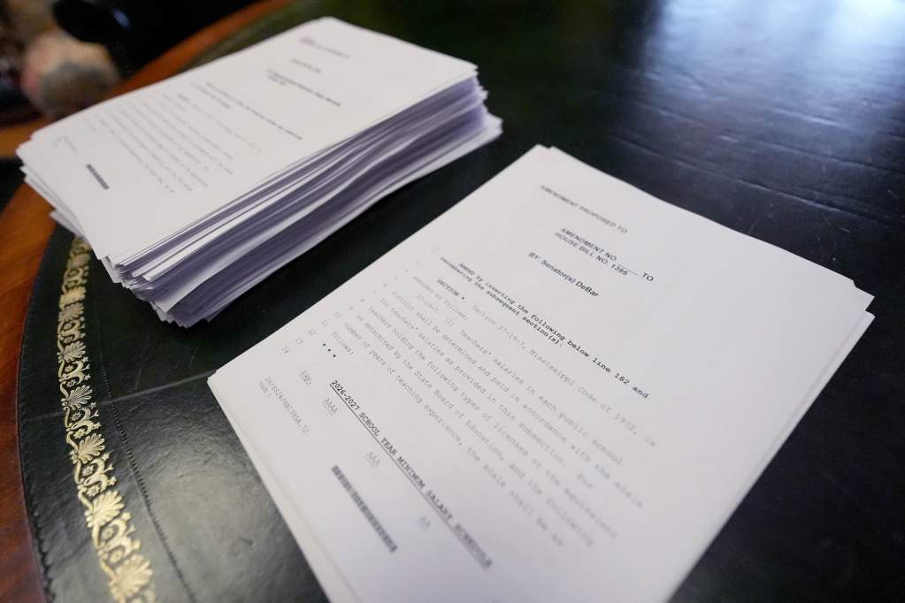Two stacks of paper sit side by side. The stack of paper on the left is significantly thicker than the right.
