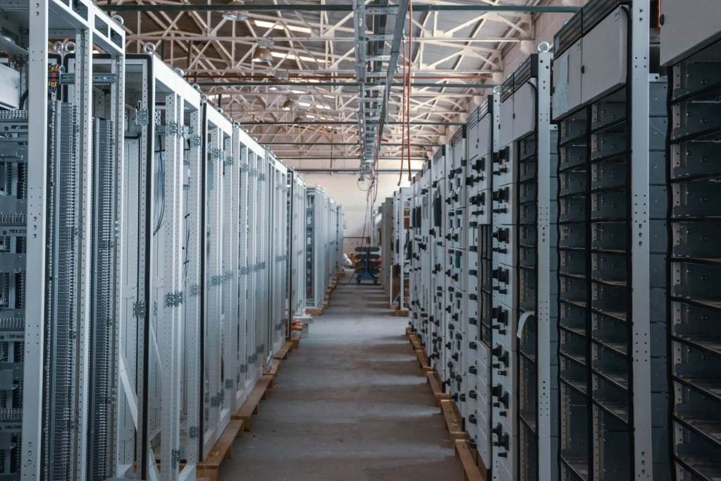 A hallway aligned with numerous computer shelves.