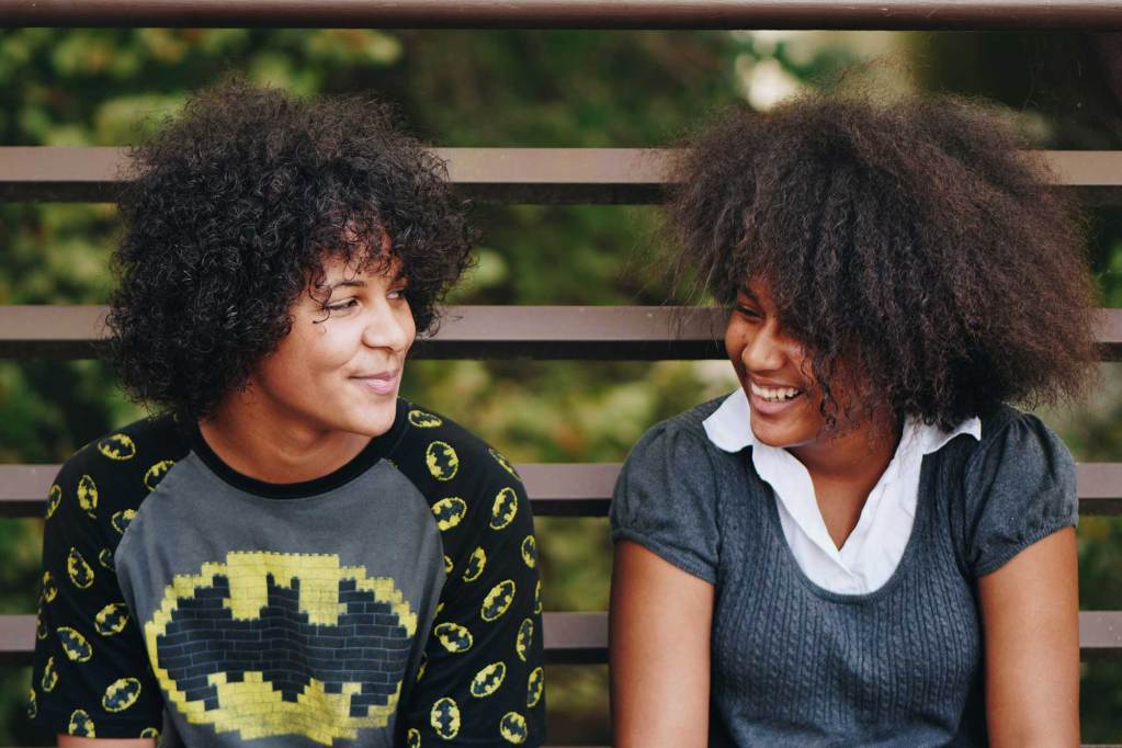 A man and woman looking at each other and smiling.