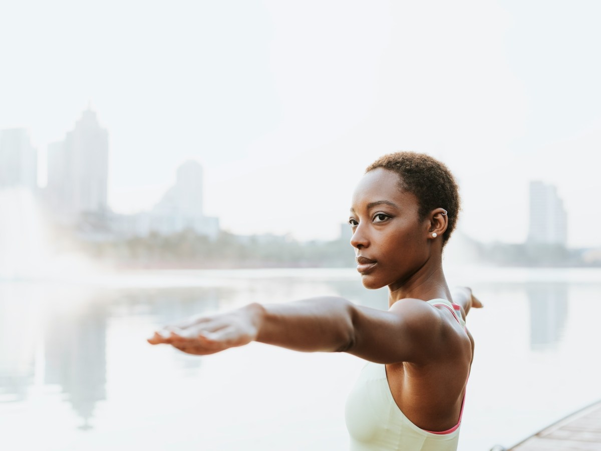 A woman with her arms outstretched in a yoga pose.