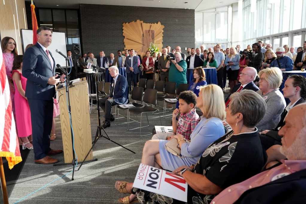 Michael Watson speaks to a room of people gathered for his press conference