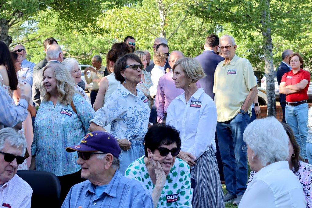 A crowd of people at an outside event supporting Philip Gunn