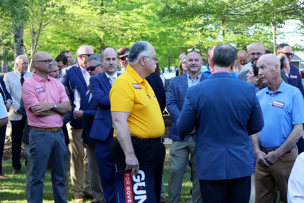 A crowd of people at an outside event supporting Philip Gunn