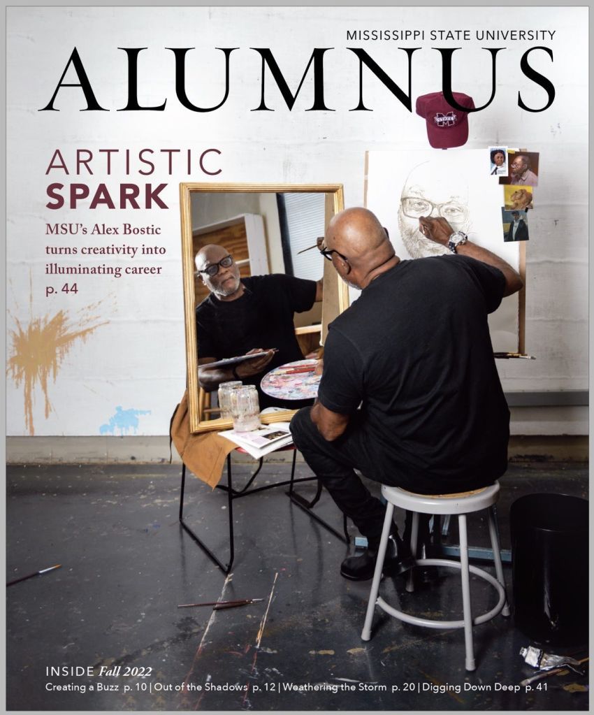 The cover for an issue of MSU Alumnus magazine featuring a man sketching a self portrait
