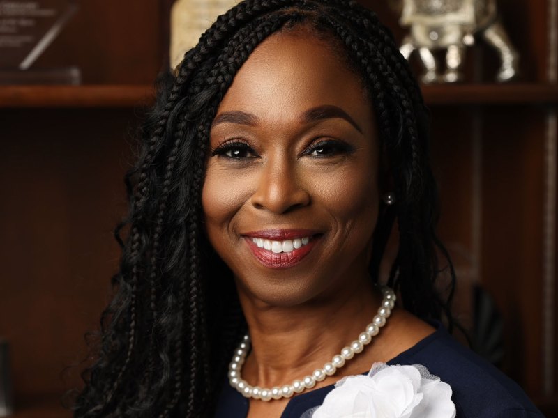 Dr. Denise Jones Gregory in a navy top and white pearl necklace