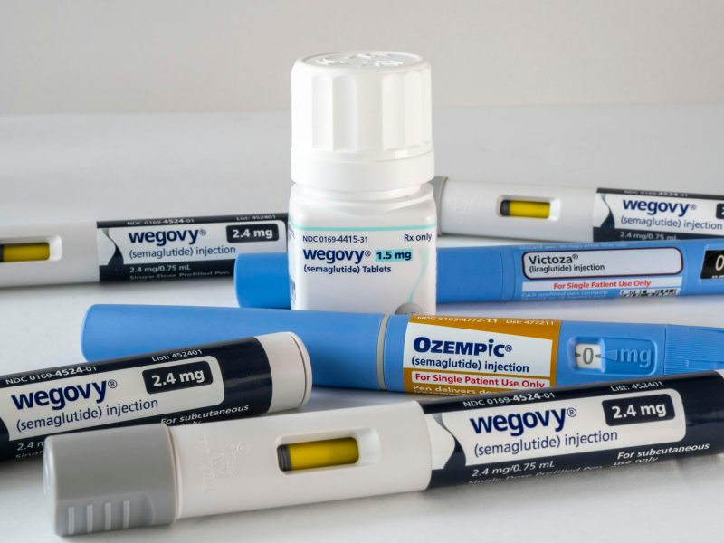 A set of Wegovy medications in injection and pill packaging