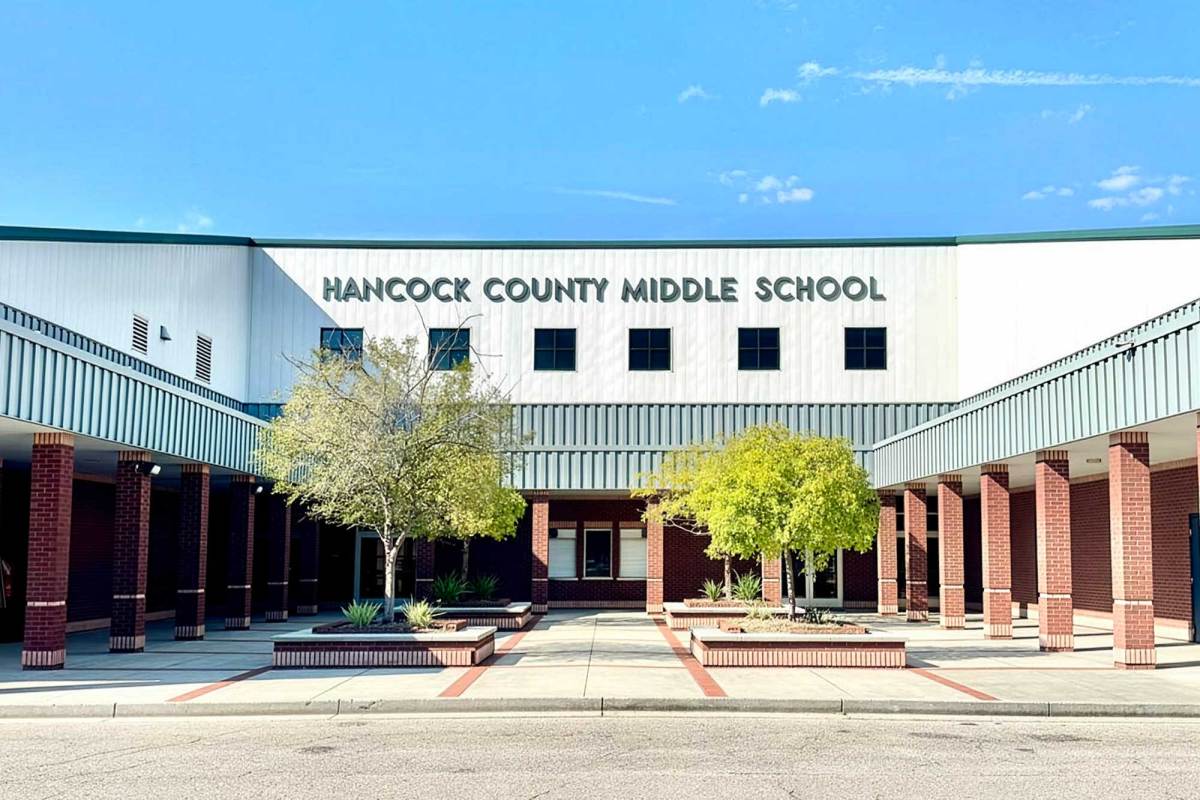 The exterior view of Hancock County Middle School, with green trees in a courtyard