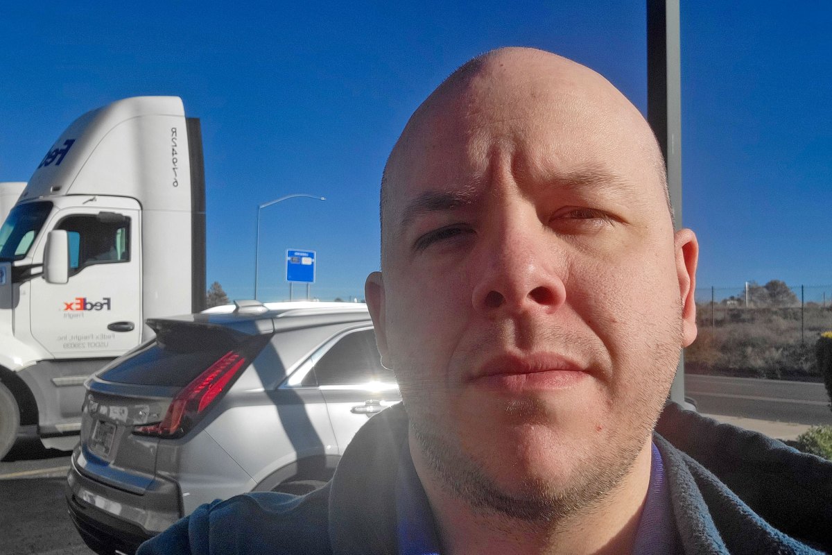 Assistant Editor Kevin Edwards seen in a selfie taken in a parking lot during his road trip