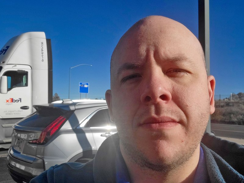 Assistant Editor Kevin Edwards seen in a selfie taken in a parking lot during his road trip