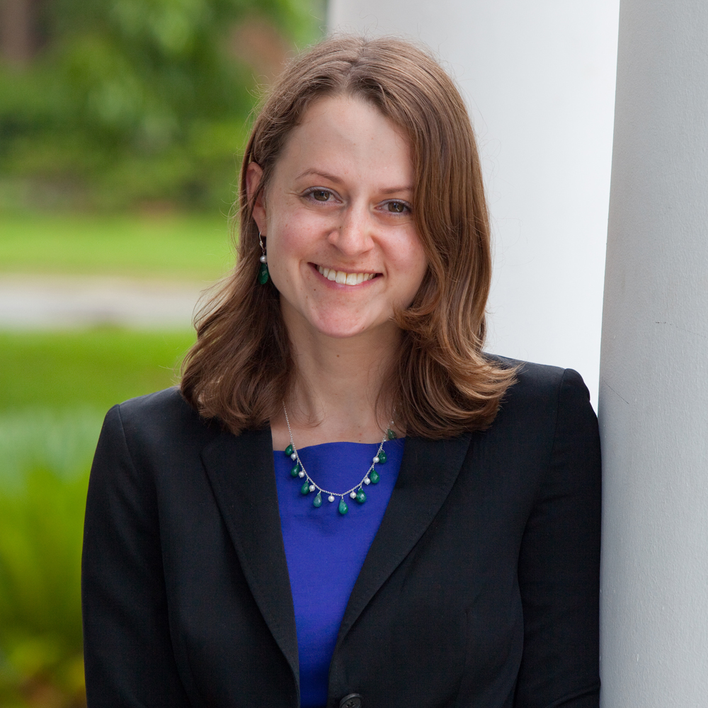 A official photo of a woman wearing a black suit and blue top