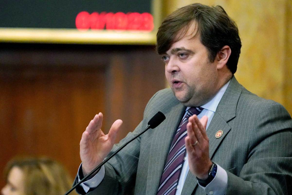 Nick Bain speaking on the house floor, gesturing with both hands
