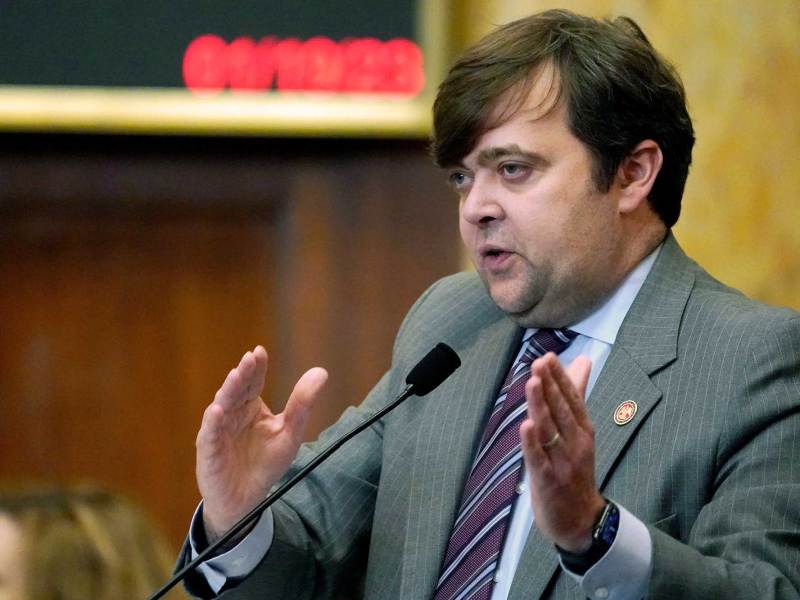 Nick Bain speaking on the house floor, gesturing with both hands