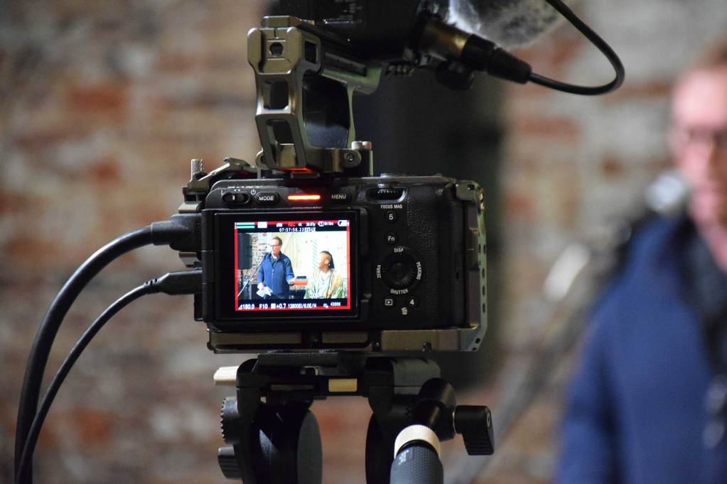 A camera records author Latoya Watkins and host Jim Dees during a session of “Thacker Mountain Radio Hour.