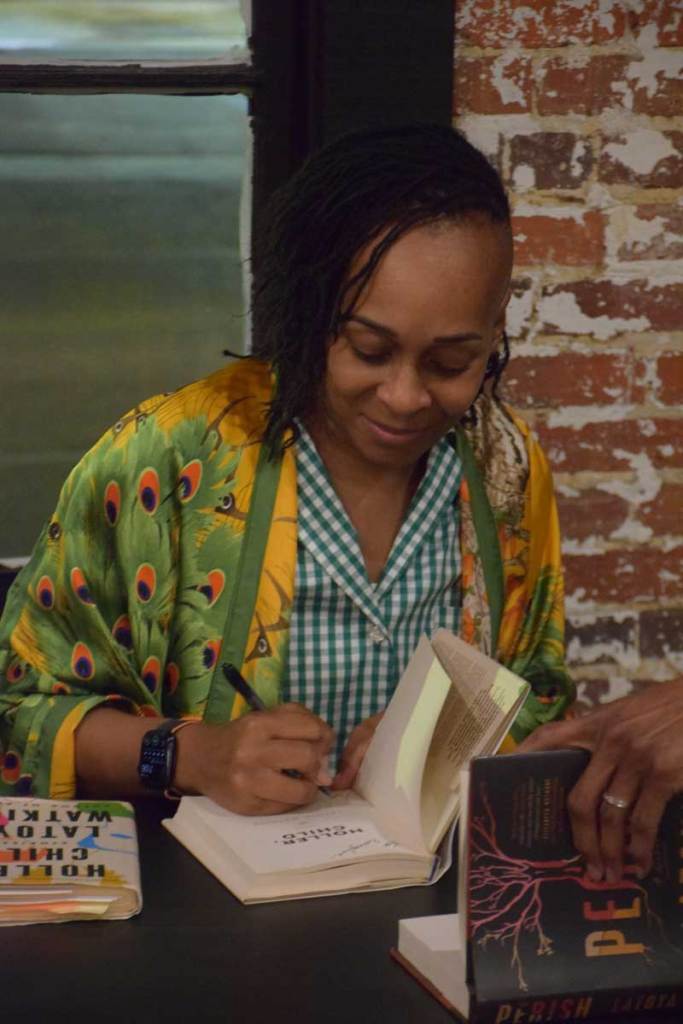 Latoya Watkins signs a book after the end of the show.