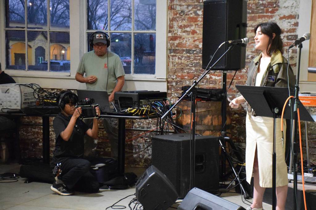 An MPB crew member records Director Lucy Gaines at the “Thacker Mountain Radio Hour.”