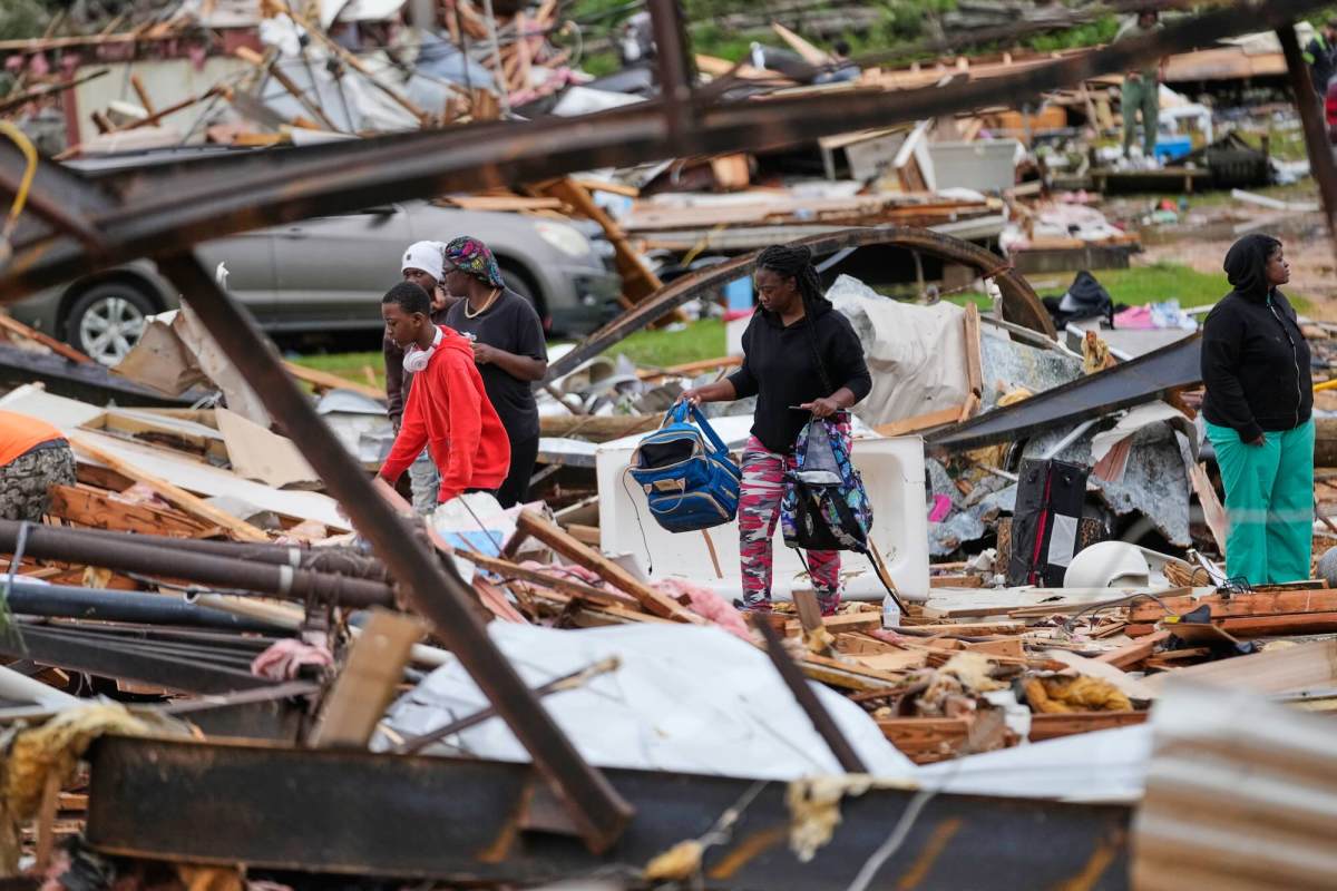 People dig through the debris of their homes after a tornado destroyed them