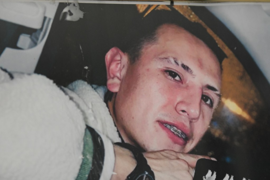 A photo of a young man that is displayed in a home.