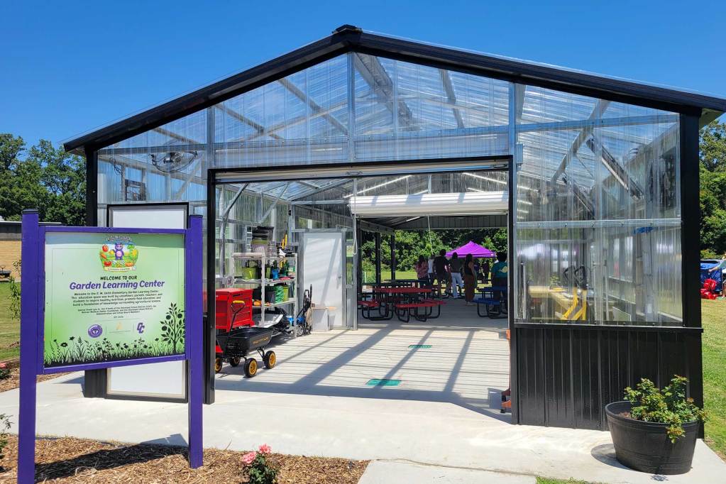 A large clear walled greenhouse labeled 'Garden Learning Center'