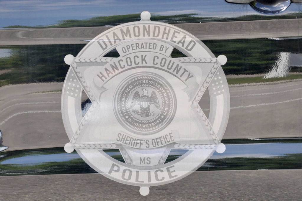 A Diamondhead Police logo is displayed on the side of a vehicle.