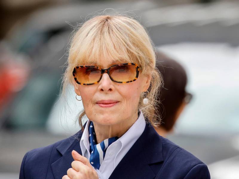 A close-up photo of E. Jean Carroll wearing a blue suit and sunglasses outsite