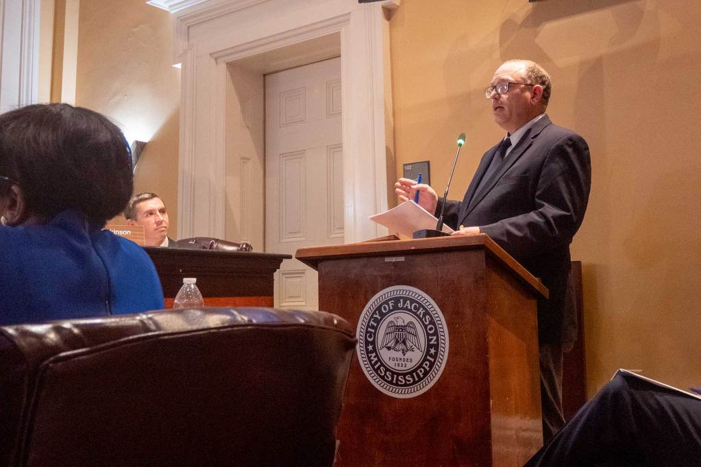 Attorney Robert Ireland speaks at a podium in front of the Jackson City Council.