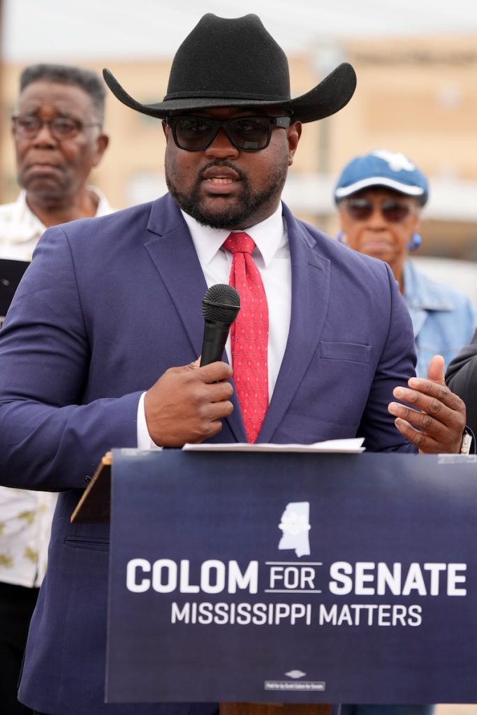 A man in a black cowboy hat speaks at a podium labeled 'Colom for Senate. Mississippi Matters.'