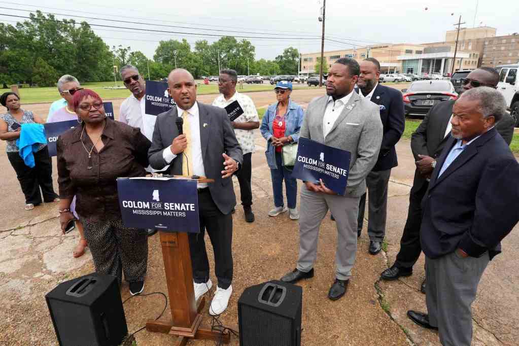 Scott Colom talks at a press conference outside of a hospital